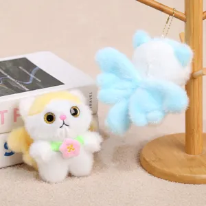 Close-up detail view of fluffy plush cat keychain featuring soft wings and cute flower pendant.