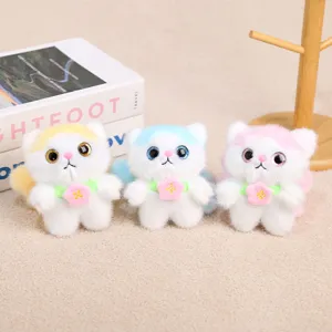 Cute plush cat keychain detail showing sparkly eyes, colorful ears and a flower collar.