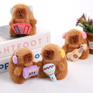 Cute musical capybara plush toy pendant holding instruments with headphones decor.