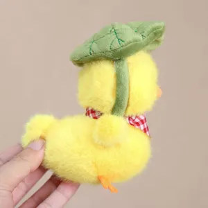 Cute yellow duck plush toy pendant with lotus leaf hat and checkered scarf accessory.