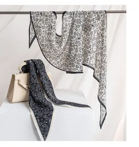 Elegant silk rhombus scarf detail, classic black and white paisley pattern, luxury style.