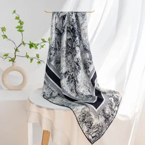 Detailed view of luxury silk square scarf with classic toile de jouy print and elegant drape.