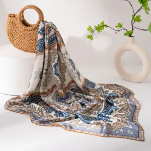 Detailed view of a vintage paisley print large silk scarf draped gracefully with elegant decor.