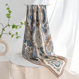 Silk scarf detail showing elegant vintage paisley pattern and luxurious silk texture.