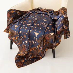 Detailed view of luxury silk square scarf with vintage bird and floral print, elegant accessory.