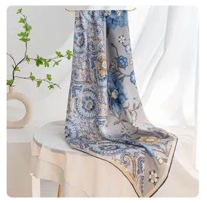 Silk square scarf detail view, elegant blue floral pattern, versatile neckerchief accessory.