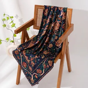 Detailed shot of a luxury dark blue floral silk scarf draped elegantly over a modern wooden chair.