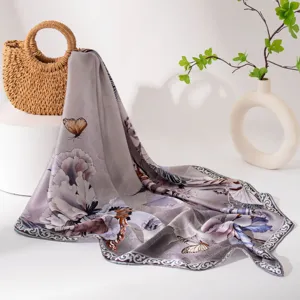 Close-up detail of the elegant floral silk square scarf featuring delicate butterfly print.