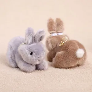 Plush rabbit keychain pendant showing cute fluffy texture and movable ear mechanism details.