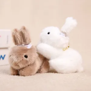 Detailed close-up of cute plush rabbit keychains with clip design and fluffy fur texture.