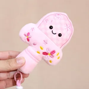 Detailed view of cute pink plush sword keychain, soft toy with cherry blossom design.