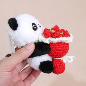 Crochet panda plush toy keychain detail, handmade cute animal bag charm with red rose bouquet.