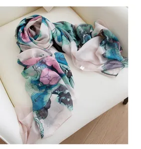 Elegant silk scarf featuring artistic floral watercolor print, lightweight draped design detail.