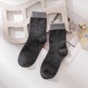Detailed view of thick wool blend mid-tube socks in dark grey, featuring cozy ribbed cuffs.