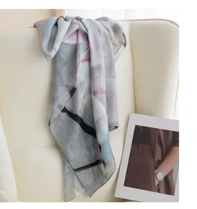Detailed view of women's artistic silk scarf with abstract watercolor print design.