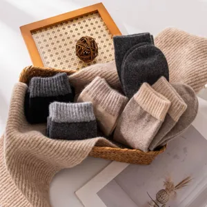 Detailed shot of cozy wool cashmere blend socks in neutral colors, arranged in a basket.