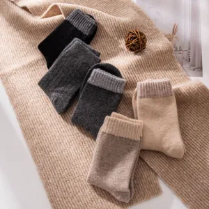 Detailed shot of cozy thick wool blend winter crew socks in assorted neutral colors, ribbed cuffs.