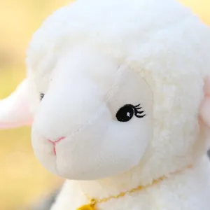 Cute plush sheep toy detail shot showcasing soft white fleece texture and fine gold necklace.