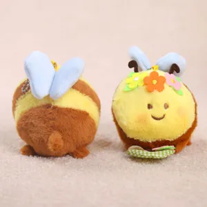 Cute bee plush toy keychain with flower decor and blue wings, soft stuffed doll pendant.