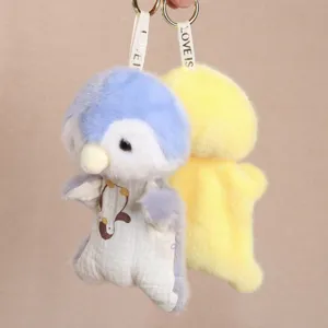 Plush penguin doll keychain detail view, soft toy pendant with cute fabric clothes.