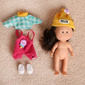 Mini doll dress up set with cute clothes, hat, and shoes for creative styling play.