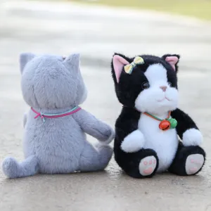 Close-up details of cute plush cat toys sitting outdoors, featuring soft texture and bells.