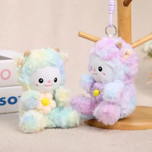 Detailed shot of colorful tie-dye plush sheep hanging toys, cute keychain charms on wood stand.