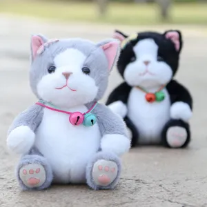 Cute sitting cat plush toy with a colorful bell collar, soft stuffed animal doll for girls.