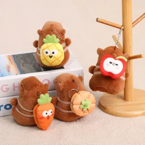 Cute capybara plush keychain with fruit backpack, detail view of soft stuffed animal toy pendant.