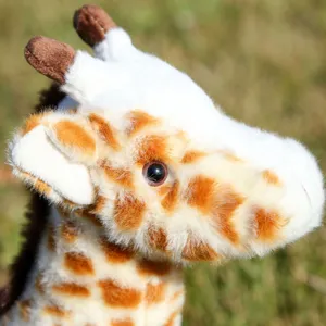Close-up detail shot of cute giraffe plush toy head, showing soft fur and realistic eyes.