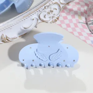 Blue acetate hair claw featuring 3D angel wings and sparkling rhinestones for stylish daily wear.
