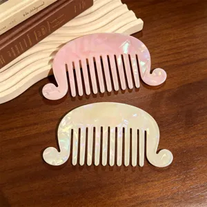 French vintage acetate hair comb detail, wavy side design, pearlescent pink and cream finish.