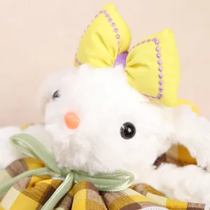 Close-up detail view of cute plush rabbit pendant featuring a yellow bow and plaid skirt.