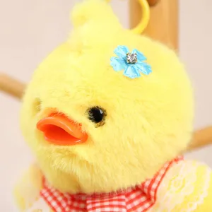 Cute yellow plush duck keychain plushie cute bag pendant with blue flower and bow ornament.