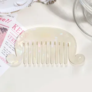 French vintage acetate hair comb with wavy curled edges and pearlescent color finish.