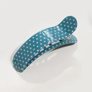 Chic blue polka dot curved hair claw clip for women, elegant daily styling hair accessory.