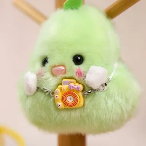 Closeup detail of cute green pear duck plush toy pendant with mini camera charm soft bag charm