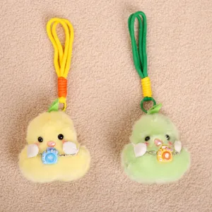 Cute plush duck pear keychain detail, soft bag charm with mini camera accessory, fluffy toy pendant.