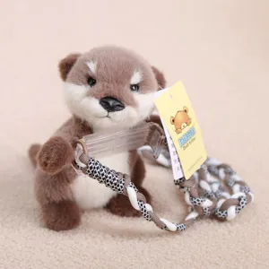 Cute plush otter animal toy featuring braided lanyard and transparent phone holder closeup.