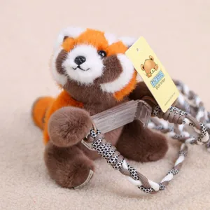 Detailed close-up view of the cute red panda plush phone holder with braided strap.