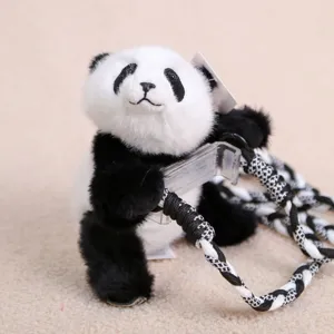 Close-up detail of a cute panda plush toy holding a transparent phone holder with braided strap