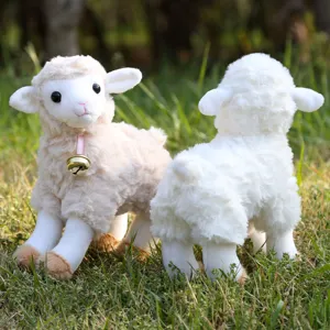 Cute standing sheep plush toy with a golden bell and pink ribbon, perfect birthday gift for kids.