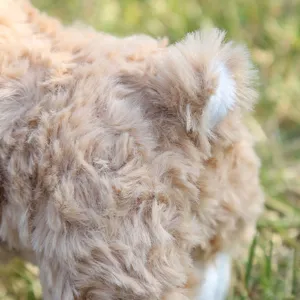 Detailed view of fluffy plush sheep tail, soft stuffed animal doll for kids gift.