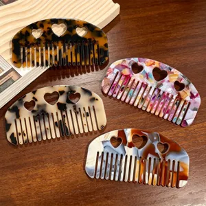 Acetate hair comb detail shot showing hollow heart patterns and beautiful vintage marbled styles.