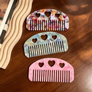 Cellulose acetate hair comb set with cute heart cutouts and vintage marbled design for women.