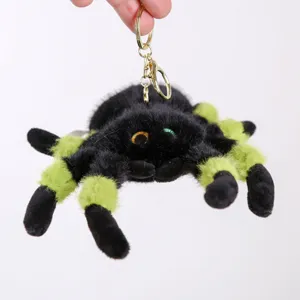 Plush spider keychain detail showing soft black and green fuzzy fur and big eyes.