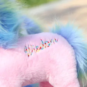 Close-up view of the cute pink unicorn plush toy showcasing soft furry texture and colorful embroidery.
