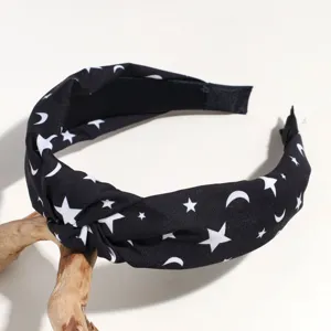 Black wide knot headband with white star and moon print, perfect detail accessory for daily wear.
