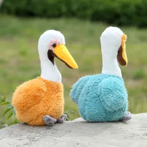 Detailed view of cute pelican plush toys in orange and blue, soft stuffed bird doll for kids.