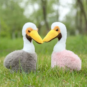 Close-up detail of cute pelican plush toy, soft stuffed animal bird doll for home decor.